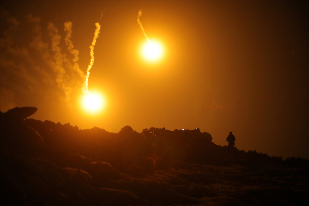 Flares are seen in the sky during fighting in the Islamic Stateu00e2u20acu2122s final enclave, in the village of Baghouz, Deir Al Zor province, Syria March 11, 2019. u00e2u20acu201d Reuters pic